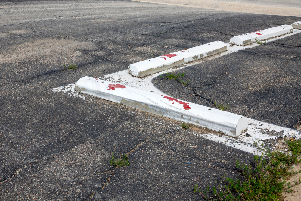 Cement,Blocks,Painted,In,White,In,A,Parking,Lot